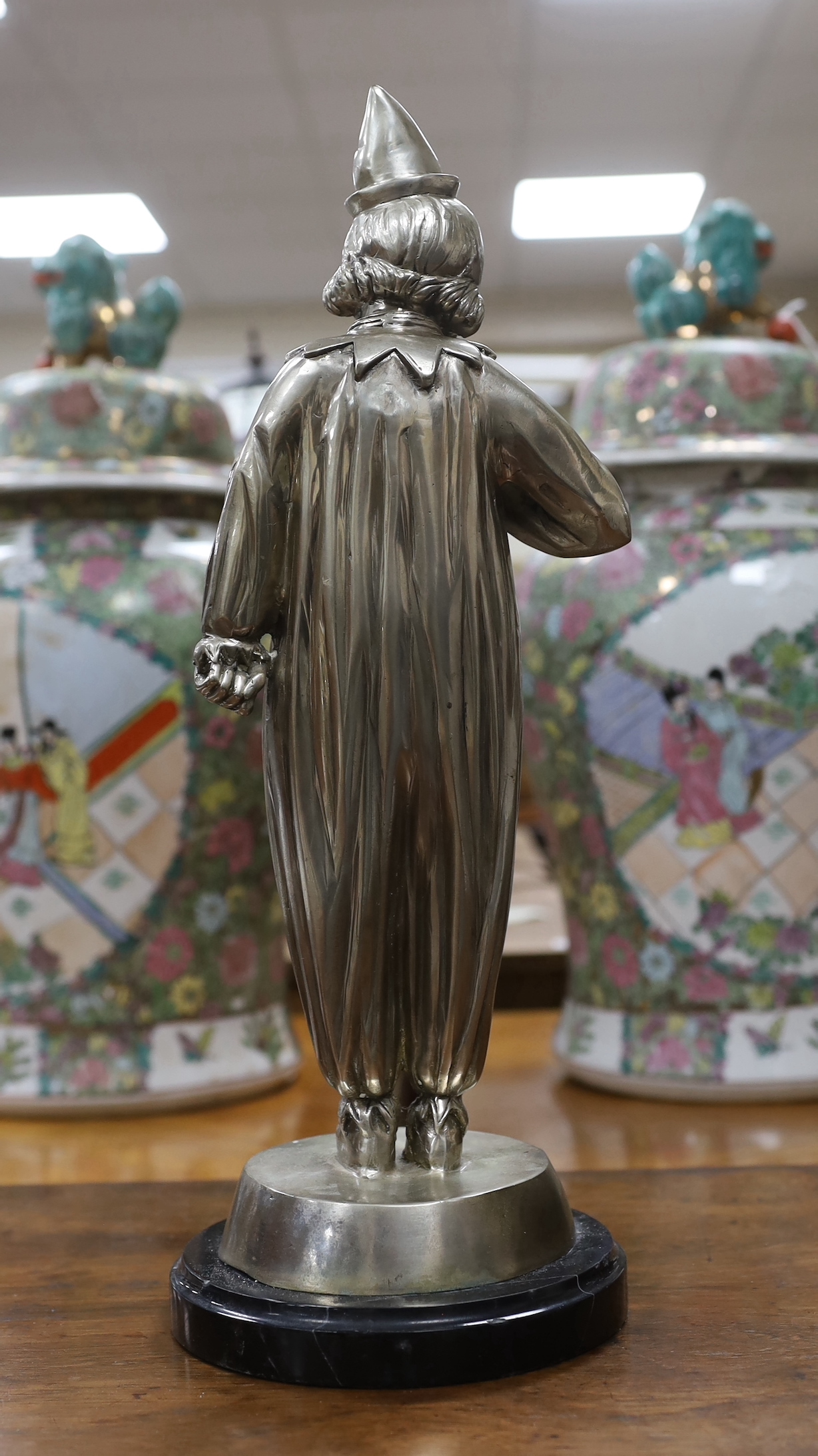 A large silvered bronze figure of a child dressed as a clown, 48cm